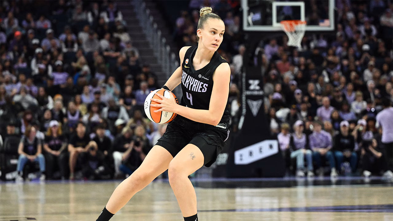 a woman holding a basketball